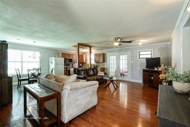 living room with plenty of natural light, crown molding, and hardwood / wood-style floors