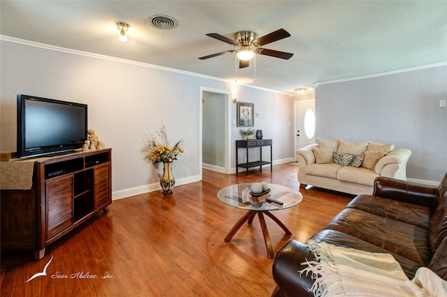 living room featuring ceiling fan, wood-type flooring, and ornamental molding