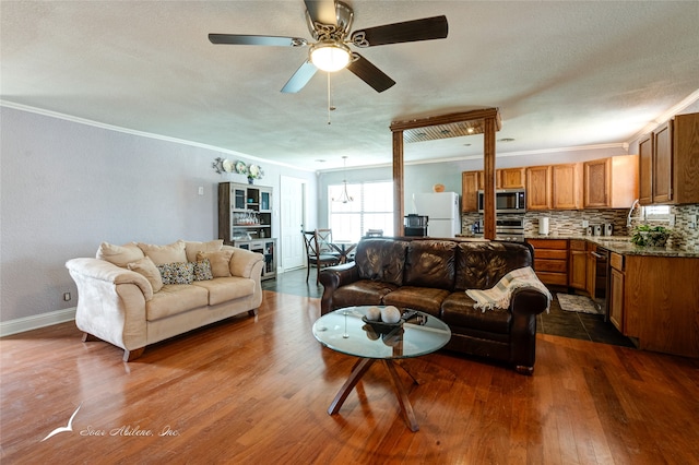 living room featuring ornamental molding, dark hardwood / wood-style flooring, and ceiling fan