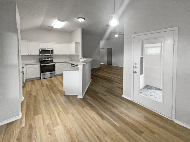 kitchen featuring appliances with stainless steel finishes, sink, pendant lighting, kitchen peninsula, and white cabinets