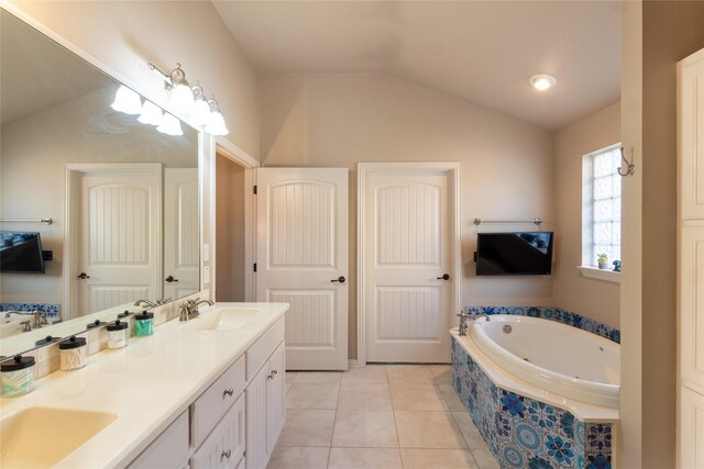 bathroom with dual vanity, tiled tub, tile patterned flooring, and lofted ceiling