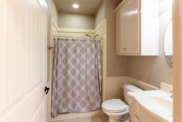 bathroom with tile patterned flooring, toilet, and vanity