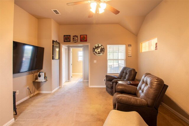 living room with light carpet, ceiling fan, and vaulted ceiling