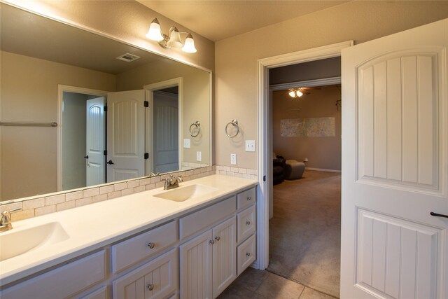 bathroom featuring tile patterned flooring and dual bowl vanity