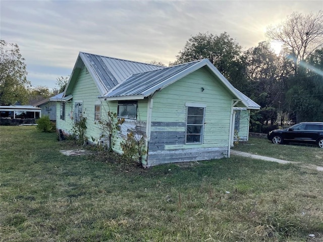 view of side of home featuring a yard