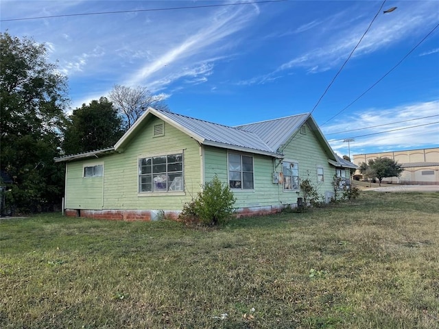 view of home's exterior with a lawn