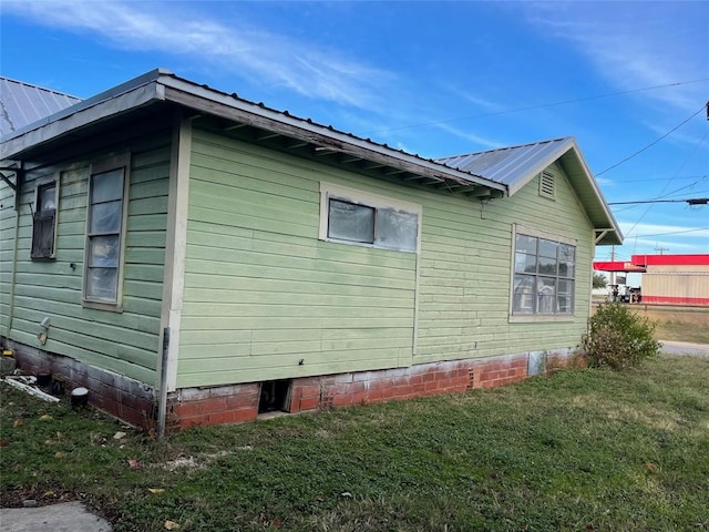 view of property exterior featuring a lawn