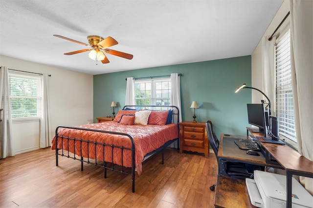 bedroom with light hardwood / wood-style flooring and ceiling fan