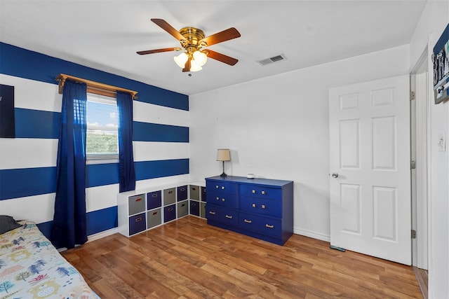 bedroom with ceiling fan and hardwood / wood-style floors