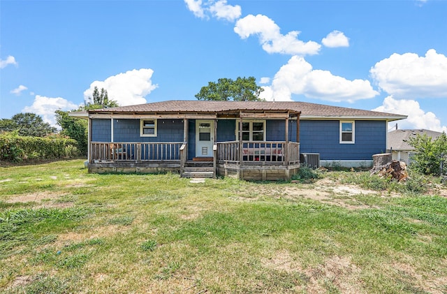 exterior space with central AC unit, a front lawn, and covered porch