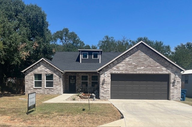 craftsman-style home featuring a garage and a front yard