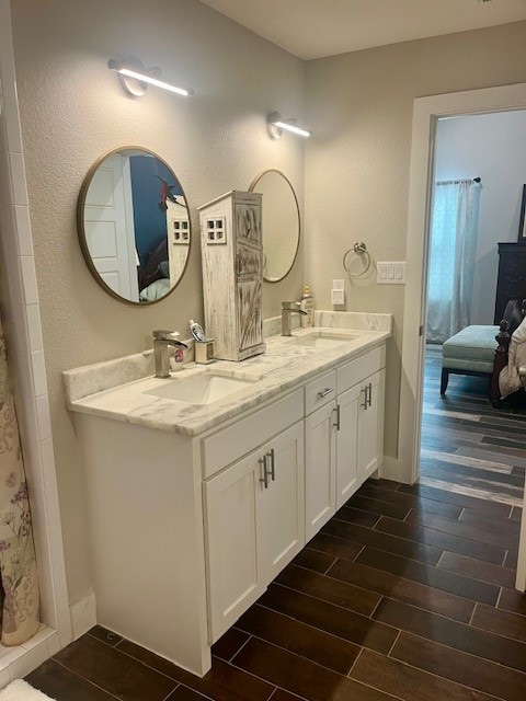 bathroom featuring hardwood / wood-style flooring and double sink vanity