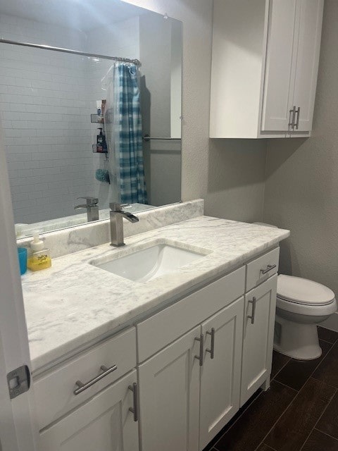 bathroom with toilet, a shower with shower curtain, vanity, and hardwood / wood-style flooring