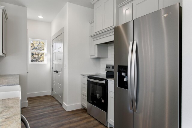 kitchen with dark hardwood / wood-style flooring, white cabinetry, appliances with stainless steel finishes, and tasteful backsplash