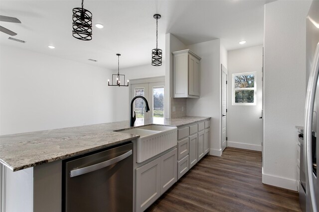 kitchen featuring dishwasher, sink, light stone counters, dark hardwood / wood-style floors, and gray cabinets