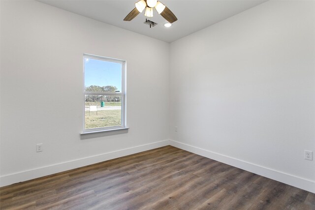 spare room featuring ceiling fan and dark wood-type flooring