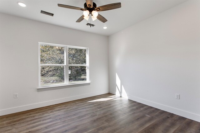 spare room with ceiling fan and dark hardwood / wood-style flooring