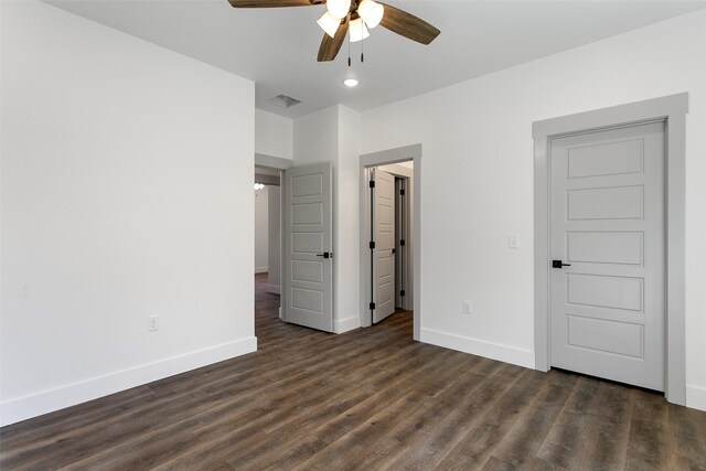 unfurnished bedroom featuring ceiling fan and dark hardwood / wood-style flooring