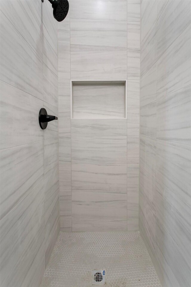 bathroom with tiled shower