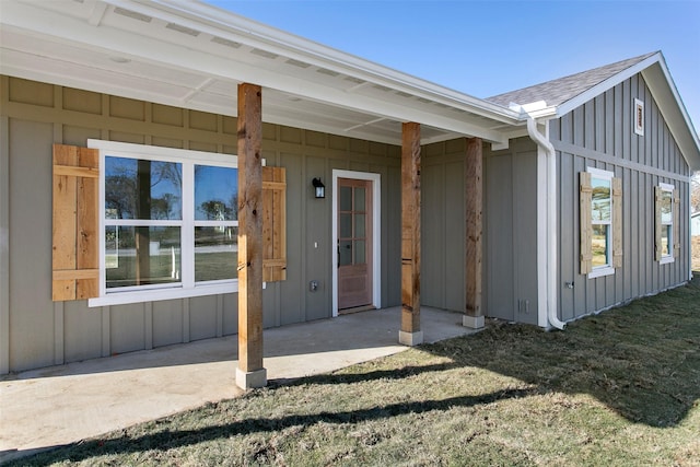 doorway to property with a lawn