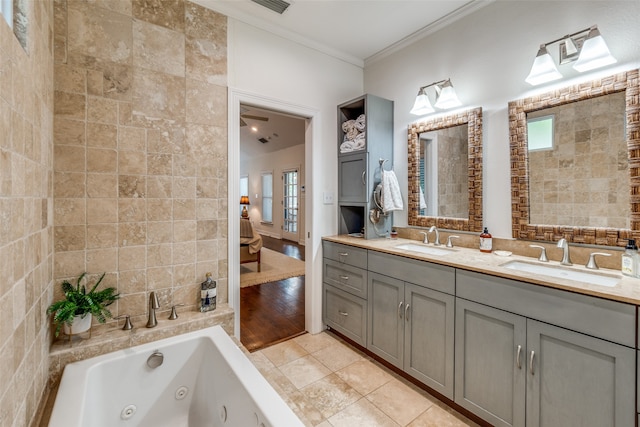 bathroom with tile patterned flooring, tile walls, crown molding, and dual bowl vanity