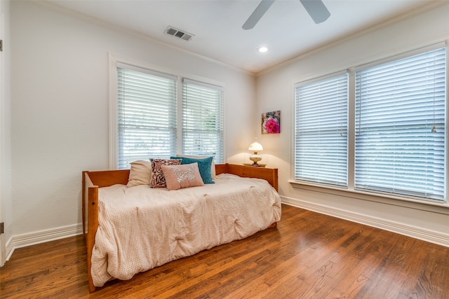 bedroom with wood-type flooring, ceiling fan, and crown molding