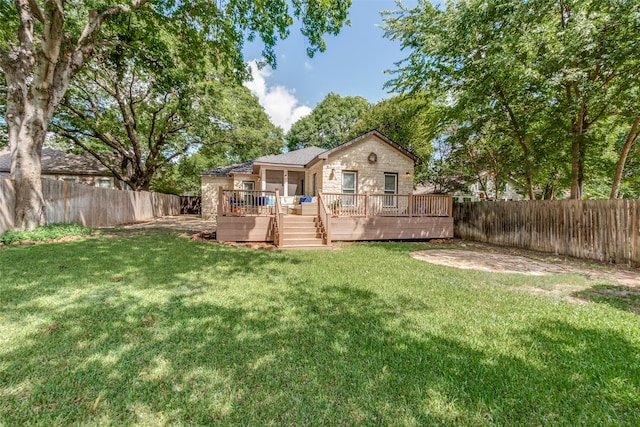 rear view of property with a deck and a lawn