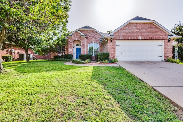 view of front of property with a garage and a front lawn