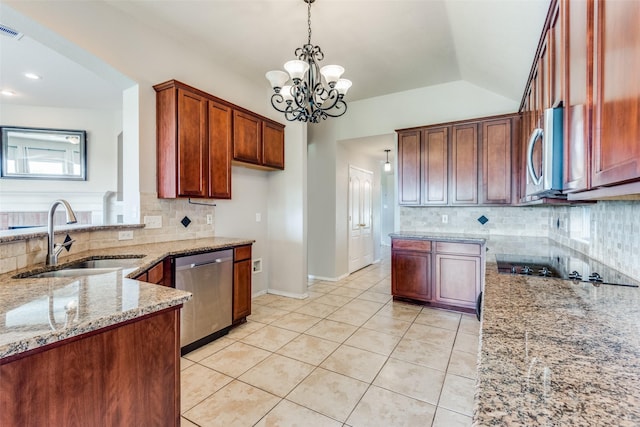 kitchen featuring pendant lighting, sink, stainless steel appliances, light stone counters, and light tile patterned flooring