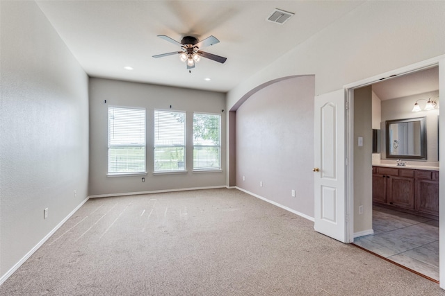 carpeted empty room with ceiling fan