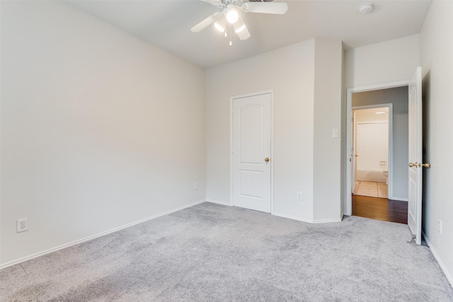 unfurnished bedroom with light colored carpet and ceiling fan