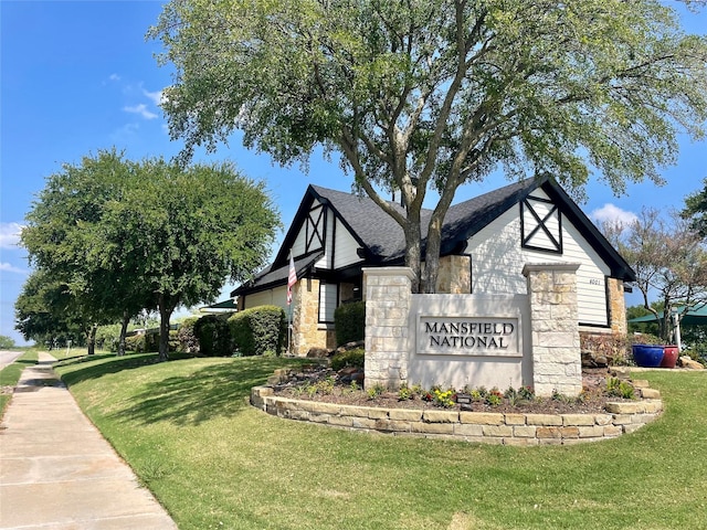 community sign featuring a lawn