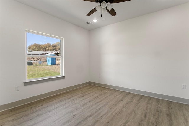 spare room featuring ceiling fan and light hardwood / wood-style floors