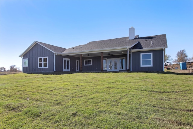 back of property featuring french doors, a yard, and ceiling fan