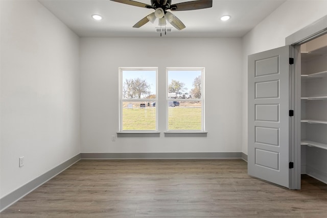 unfurnished bedroom with ceiling fan and light hardwood / wood-style floors