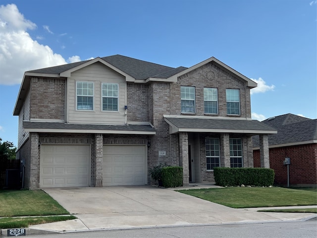 view of front of house with a garage and a front lawn