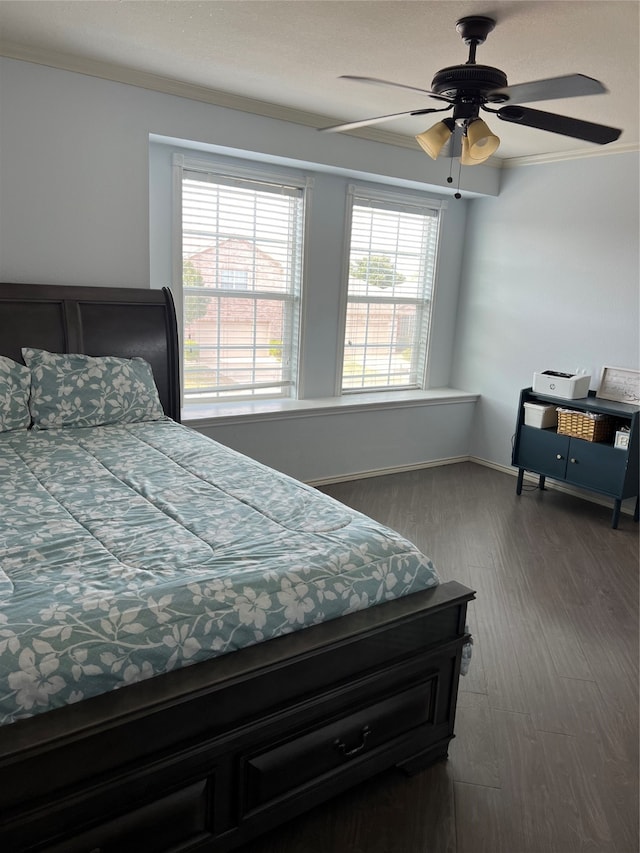 bedroom with wood-type flooring, ceiling fan, and crown molding