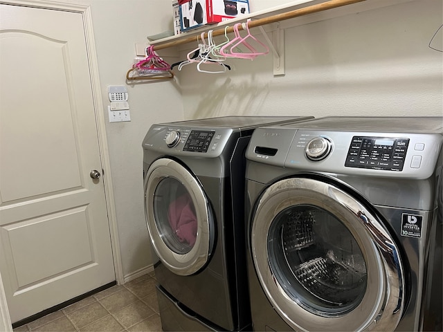 laundry room featuring washing machine and dryer and light tile patterned floors