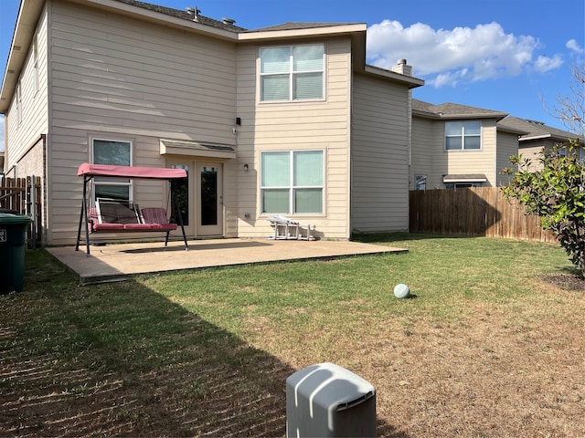 back of property featuring a yard and a patio area