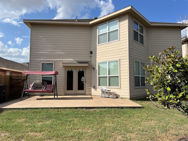 rear view of house featuring a patio and a lawn