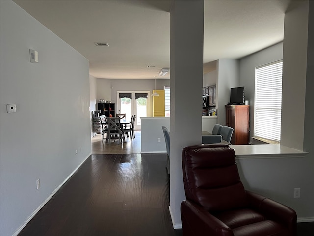 sitting room featuring wood-type flooring and french doors