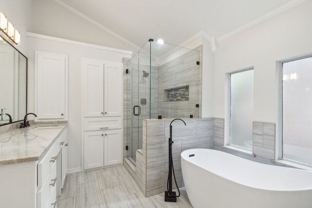 bathroom with vanity, tile patterned floors, independent shower and bath, crown molding, and lofted ceiling