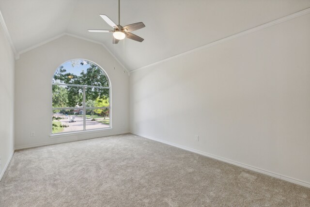 carpeted spare room featuring vaulted ceiling, crown molding, and ceiling fan