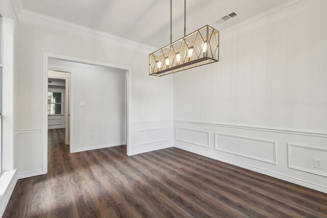 unfurnished dining area featuring ornamental molding, an inviting chandelier, and dark hardwood / wood-style floors