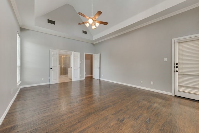 empty room featuring dark wood-type flooring, ceiling fan, ornamental molding, and high vaulted ceiling