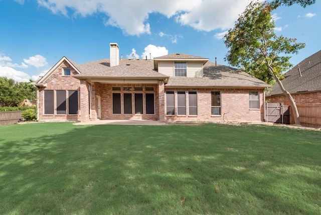 back of house with a yard and a patio area