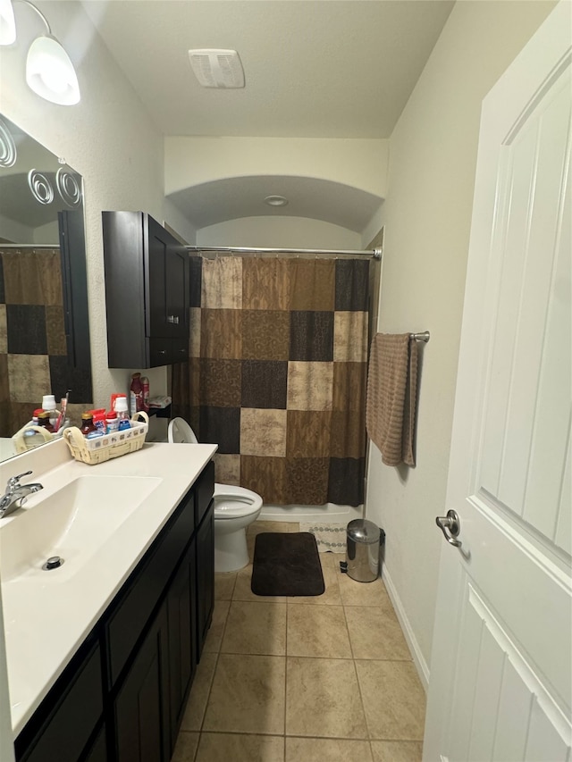 bathroom featuring toilet, vanity, tile patterned floors, and a shower with shower curtain