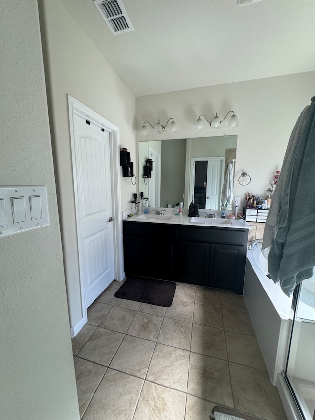 bathroom with tile patterned flooring, vanity, and shower with separate bathtub