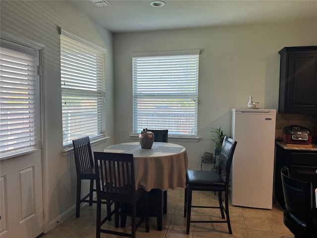 dining space with light tile patterned flooring