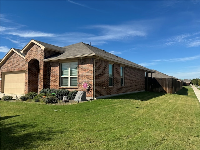 view of side of home with a yard and a garage